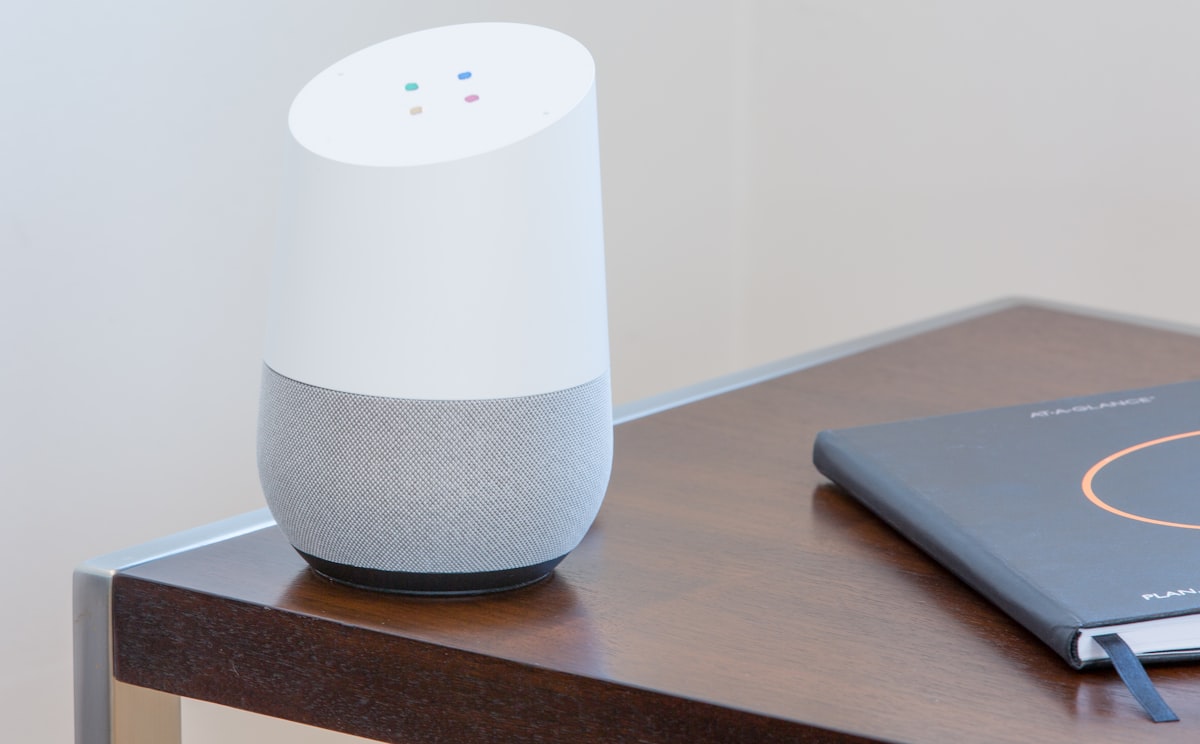 A voice-controlled smart speaker on a living-room side table